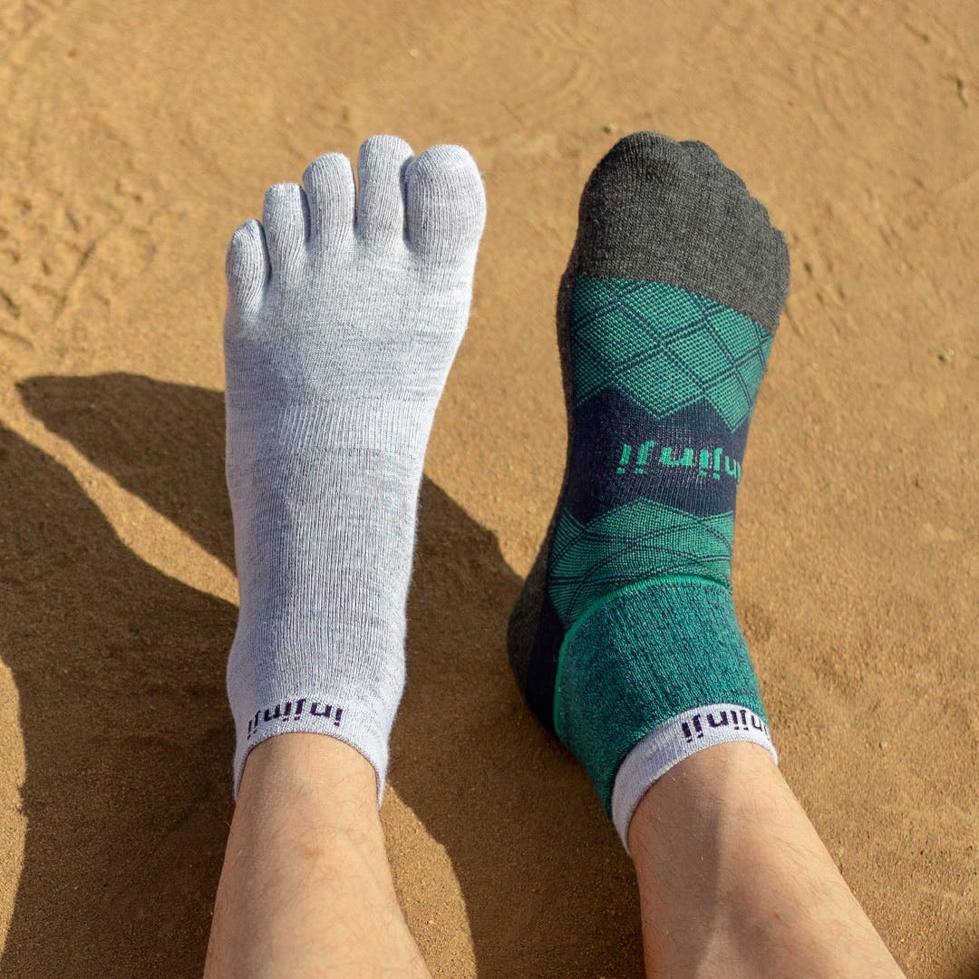 One foot showing a pair of running socks, another foot showing a pair of running toesocks