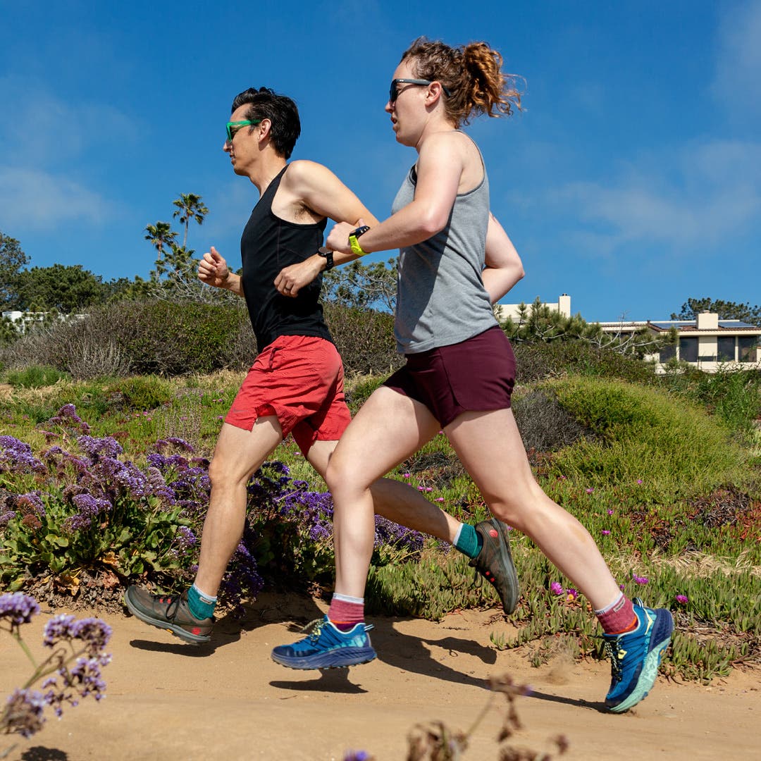 Two people running on a trail in ankle running socks