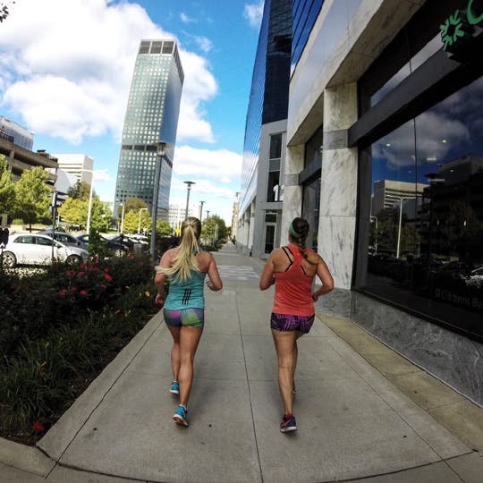 Lindsey and Kati running together downtown. Team Injinji's Lindsey and Kati training together.