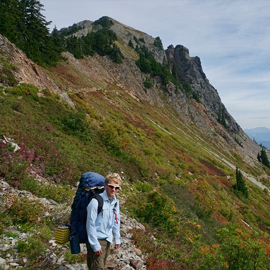 Male backpacker posing on a trail in the Cascade mountain range in Washington. 