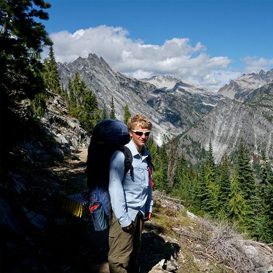 Male backpacker on a trail through the Cascade mountain range in Washington. Male backpacker on a trail through the Cascade mountain range in Washington.