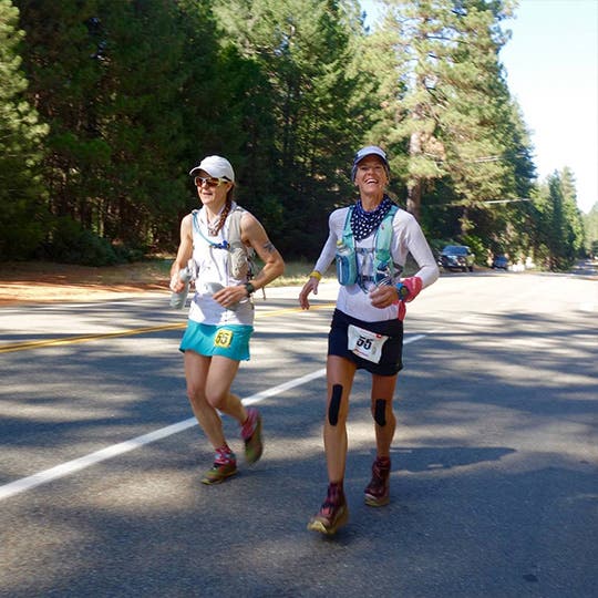 Two female athletes running at the Western States 100 Mile Endurance Run. Two female athletes running at the Western States 100 Mile Endurance Run.
