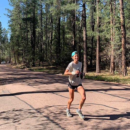 Female runner racing on a dirt trail in central Arizona. Female runner racing on a dirt trail in central Arizona.